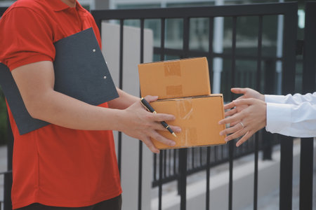 Asian Woman Receiving Product from delivery man at Home, Young Owner Woman Order Product from...