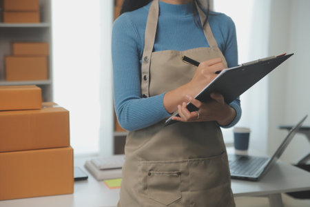 Business woman start up small business entrepreneur SME success .freelance woman working at home with Online Parcel delivery. SME and packaging deliveryconceptの写真素材