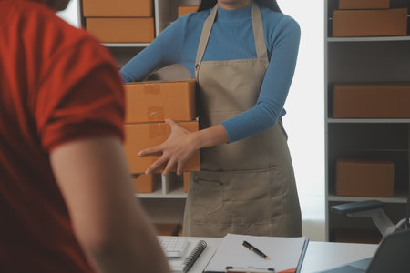 Business woman start up small business entrepreneur SME success .freelance woman working at home with Online Parcel delivery. SME and packaging deliveryconceptの写真素材