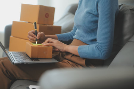 Business woman start up small business entrepreneur SME success .freelance woman working at home with Online Parcel delivery. SME and packaging deliveryconceptの写真素材