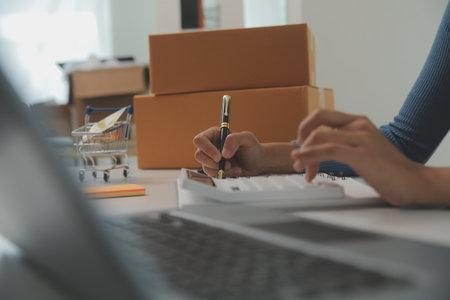 Business woman start up small business entrepreneur SME success .freelance woman working at home with Online Parcel delivery. SME and packaging deliveryconceptの写真素材