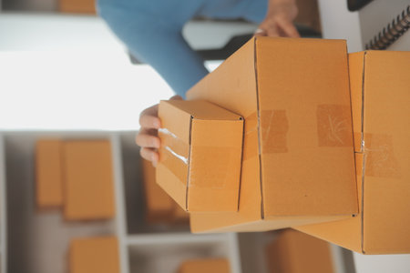Business woman start up small business entrepreneur SME success .freelance woman working at home with Online Parcel delivery. SME and packaging deliveryconceptの写真素材