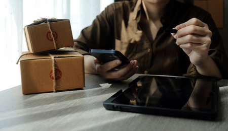 Business woman start up small business entrepreneur SME success .freelance woman working at home with Online Parcel delivery. SME and packaging deliveryconceptの写真素材