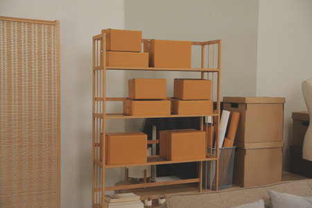 Beautiful young couple in love having fun unpacking things from cardboard boxes while moving in...