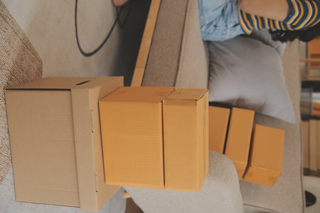 Startup small business owner working with computer at workplace. Freelance two woman seller check product order. Packing goods for delivery to customer. Online selling. E-commerce. Online Shoppingの写真素材