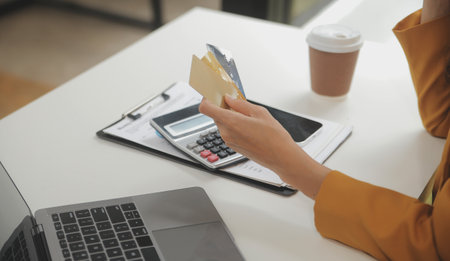 Women holding credit card and using smartphones at home.Online shopping, internet banking, store...