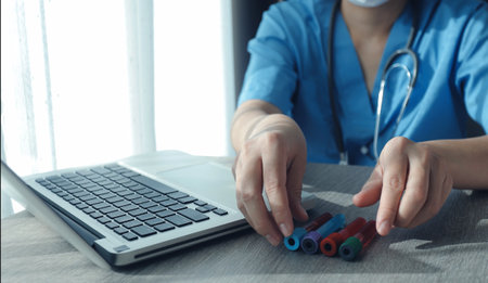 Doctor holding blood vessels for analysis and checking blood in research laboratory blood sample...