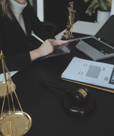Male lawyer working with contract papers and wooden gavel on tabel in courtroom. justice and law ,attorney, court judge, concept.の写真素材