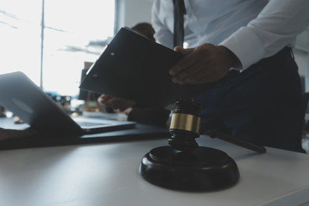 Male lawyer working with contract papers and wooden gavel on tabel in courtroom. justice and law ,attorney, court judge, concept.の写真素材