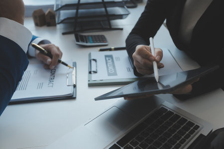 Real estate agent and customer signing contract to buy house, insurance or loan real estate.rent a house,get insurance or loan real estate or property.の写真素材