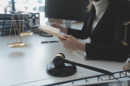 Male lawyer working with contract papers and wooden gavel on tabel in courtroom. justice and law ,attorney, court judge, concept.の写真素材