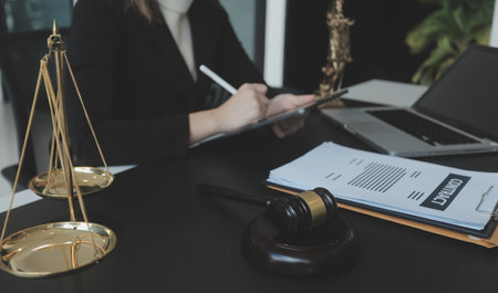 Male lawyer working with contract papers and wooden gavel on tabel in courtroom. justice and law ,attorney, court judge, concept.の写真素材