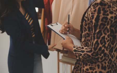 Business woman with friend working online for selling and e-commerce business. Freelancer at home for startup and SME entrepreneur.の写真素材