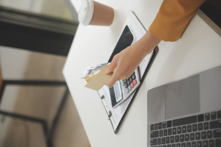 Women holding credit card and using smartphones at home.Online shopping, internet banking, store online, payment, spending money, e-commerce payment at the store, credit card, conceptの写真素材