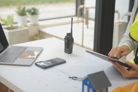 Engineer Teamwork Meeting, Drawing working on blueprint meeting for project working with partner on model building and engineering tools in working site, Construction and structure concept.の写真素材