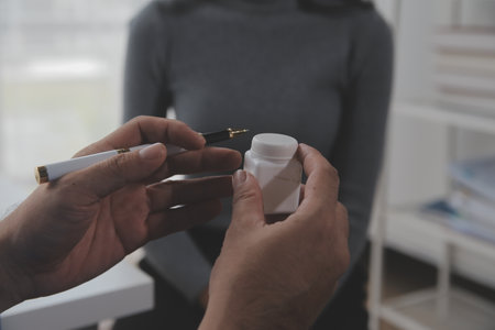 Asian doctor woman visited patient woman to diagnosis and check up health at home or private hospital. Female patient explain health problem and symptoms to doctor .Health care premium service at homeの写真素材