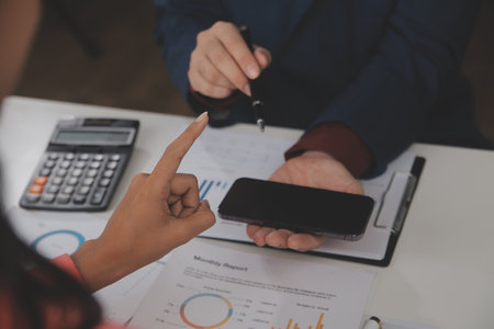 Close up Business woman using calculator and laptop for do math finance on wooden desk, tax, accounting, statistics and analytical research conceptの写真素材