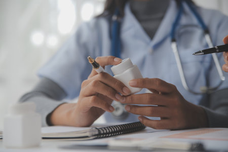 Doctors, nurse or laptop in night teamwork, medical research or surgery planning in wellness hospital. Talking, thinking or healthcare women on technology for collaboration help or life insurance appの写真素材