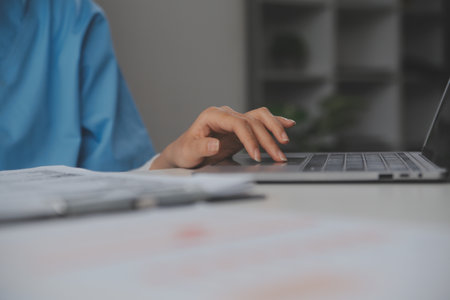 Doctors, nurse or laptop in night teamwork, medical research or surgery planning in wellness hospital. Talking, thinking or healthcare women on technology for collaboration help or life insurance appの写真素材