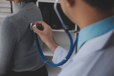 Asian doctor woman visited patient woman to diagnosis and check up health at home or private hospital. Female patient explain health problem and symptoms to doctor .Health care premium service at homeの写真素材
