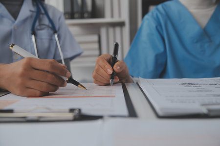 Doctors, nurse or laptop in night teamwork, medical research or surgery planning in wellness hospital. Talking, thinking or healthcare women on technology for collaboration help or life insurance appの写真素材
