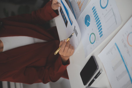 Close up Business woman using calculator and laptop for do math finance on wooden desk, tax, accounting, statistics and analytical research conceptの写真素材