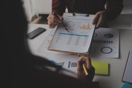 Close up Business woman using calculator and laptop for do math finance on wooden desk, tax, accounting, statistics and analytical research conceptの写真素材