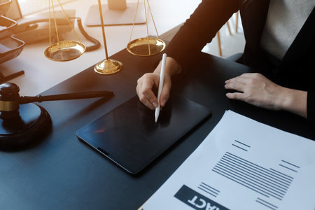 Male lawyer working with contract papers and wooden gavel on tabel in courtroom. justice and law ,attorney, court judge, concept.の写真素材