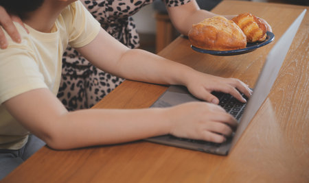 Caucasian attractive couple baking bakery with son in kitchen at home. Happy Family-father, mother and young boy having fun spending time together using ingredient making foods. Activity relationship.の写真素材