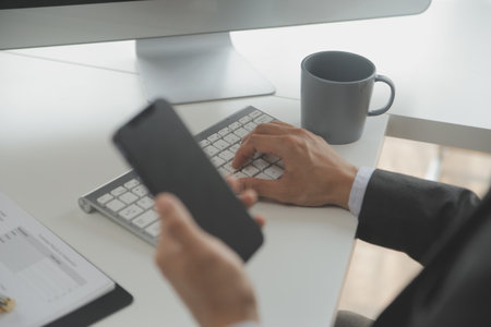 Close up Business woman using calculator and laptop for do math finance on wooden desk, tax, accounting, statistics and analytical research conceptの写真素材