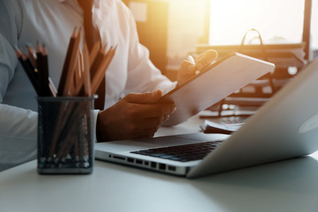 Close up of Business team analyzing income charts and graphs with modern laptop computer. Business analysis and strategy concept.の写真素材