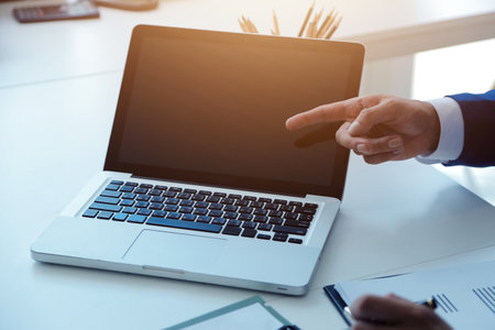 Entrepreneur Asian businessman and businesswoman discussing new business project in tablet in modern Meeting In Modern Office, Asian business casual concept.の写真素材