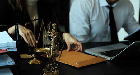 Judge gavel with Justice lawyers having team meeting at law firm in background. Concepts of law.の写真素材