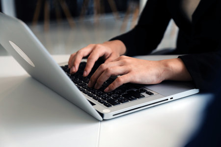 Close up of Business team analyzing income charts and graphs with modern laptop computer. Business...