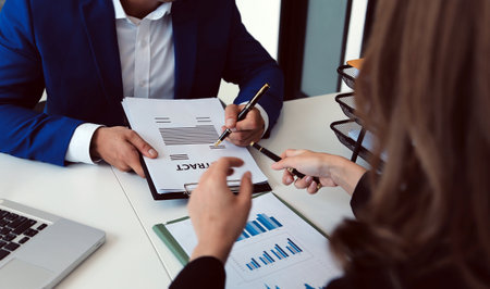 Entrepreneur Asian businessman and businesswoman discussing new business project in tablet in modern...