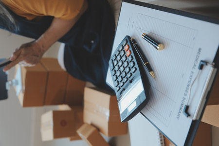 Startup SME small business entrepreneur of freelance Asian woman using a laptop with box Cheerful success Asian woman her hand lifts up online marketing packaging box and delivery SME idea conceptの写真素材