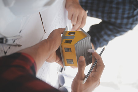 Close up of civil male engineer asian working on blueprint architectural project at construction...