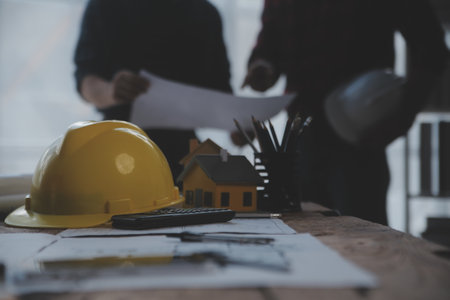Close up of civil male engineer asian working on blueprint architectural project at construction site at desk in office.の写真素材