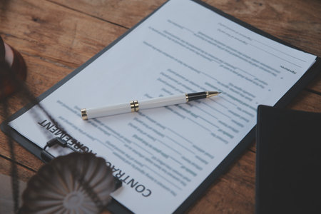 Justice and Law concept. Legal counsel presents to the client a signed contract with gavel and legal law or legal having team meeting at law firm in backgroundの写真素材