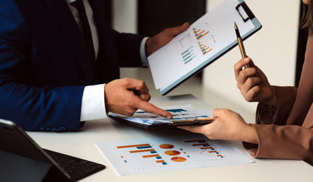 Team of business people working together in the meeting room office, teamwork background charts and...