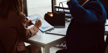 Team of business people working together in the meeting room office, teamwork background charts and...