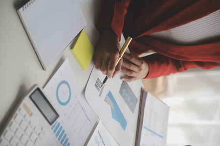 Close up Business woman using calculator and laptop for do math finance on wooden desk, tax, accounting, statistics and analytical research conceptの写真素材