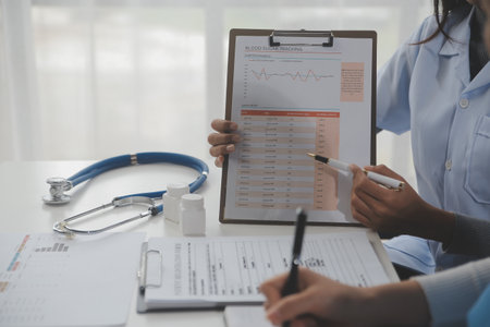 Doctors, nurse or laptop in night teamwork, medical research or surgery planning in wellness hospital. Talking, thinking or healthcare women on technology for collaboration help or life insurance appの写真素材