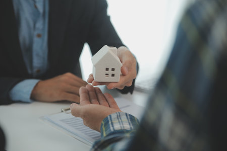 Real estate agent and customer signing contract to buy house, insurance or loan real estate.rent a house,get insurance or loan real estate or property.の写真素材