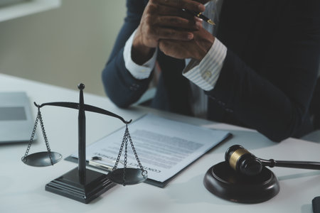 Business and lawyers discussing contract papers with brass scale on desk in office. Law, legal...