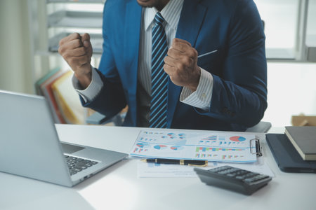 Close up Business woman using calculator and laptop for do math finance on wooden desk, tax, accounting, statistics and analytical research conceptの写真素材