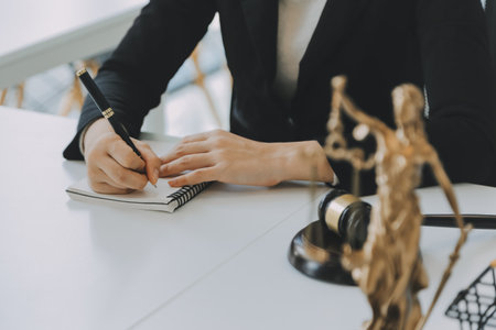 Judge gavel with Justice lawyers having team meeting at law firm in background. Concepts of law.の写真素材