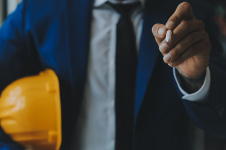 Civil Engineer Hispanic smiling with Constuction backgrounds, use for banner cover. Success in target of project goal Handsome Middle Eastern worker.の写真素材