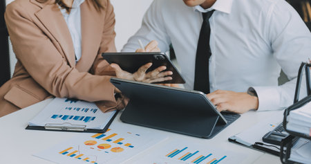 Team of business people working together in the meeting room office, teamwork background charts and...