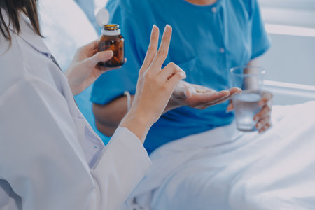 Women Asian doctors hold the patient hand and encourage and provide medical advice While checking the patient health in bed. Concept of Care and compassion, antenatal care, Threatened abortionの写真素材